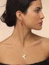 Model wearing gold bird pendant inspired by Gazza Ladra