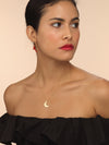 Model wearing gold moon necklace with thin chain.