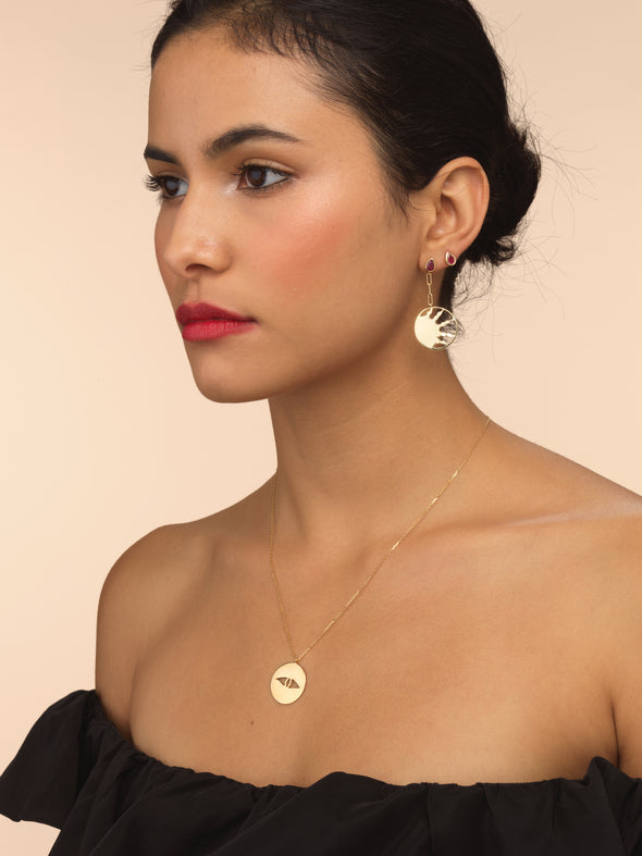 Model wearing pink sapphire stud earring. 