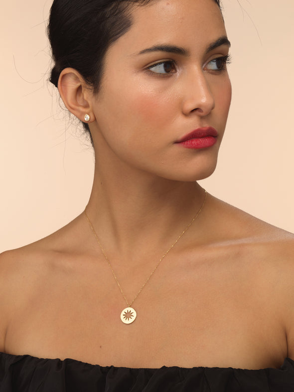 Model wearing small sun beam necklace.