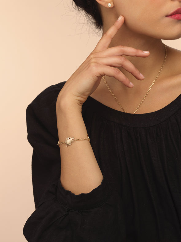 Model wearing gold falco (falcon) bracelet